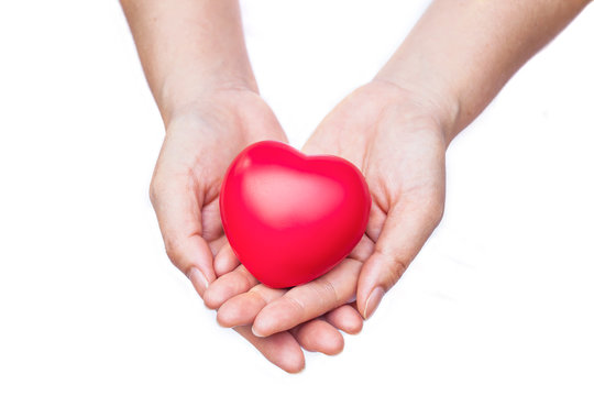 hand holding a red heart on white background