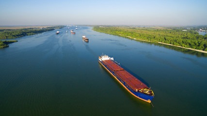 Caravan of barges on the river - obrazy, fototapety, plakaty