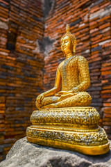 Golden Buddha image on rock