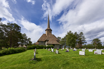 Fototapeta na wymiar A nice white stave church in small town of Norway