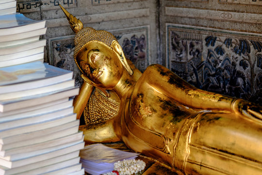 Reclining Buddha gold statue  with Prayer book