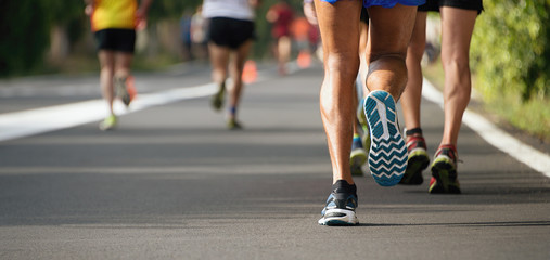 Marathon running race, people feet on city road