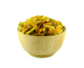 Pasta in wooden bowl on white background.