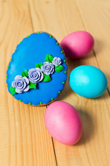 Easter homemade gingerbread cookie and eggs on wooden table