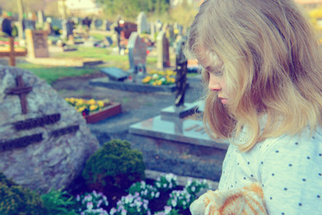 sad girl in front of grave