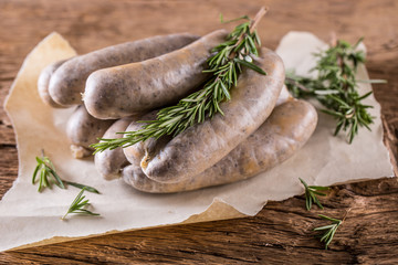 Sausages. Raw pork sausages on oak wooden table.