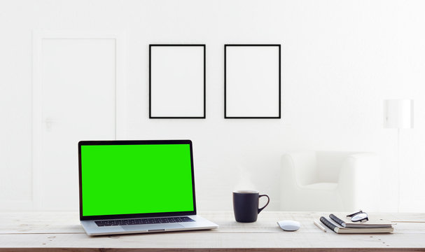 laptop computer showing green screen in home interior background