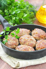 Cutlets with vegetables and herbs in pan