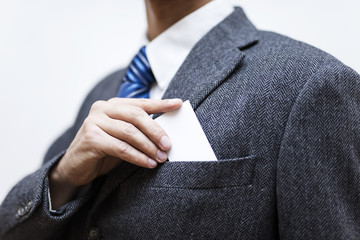 Businessman taking a blank business card out of his pocket