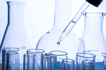 Dropping chemical liquid to test tubes, laboratory research and development concept