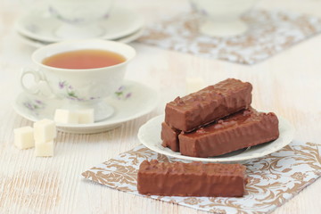 Tea and waffles with chocolate cream and nuts