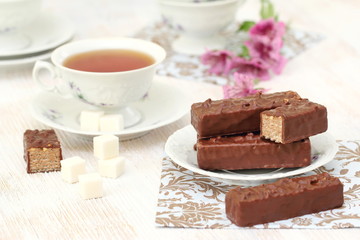 Tea and waffles with chocolate cream and nuts