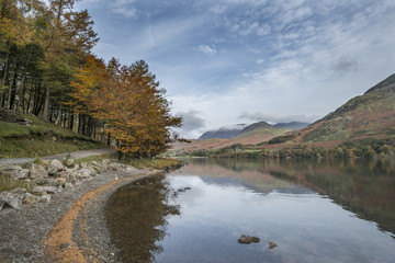 Stuning Autumn Fall landscape image of Lake Buttermere in Lake District England