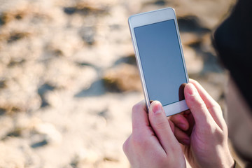 Both hands hold the phone