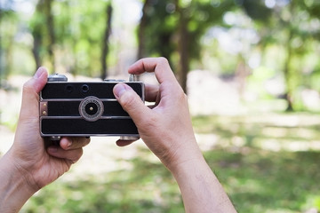 Man taking photo using old retro camera