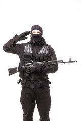 Portrait of soldier holding a rifle and saluting
