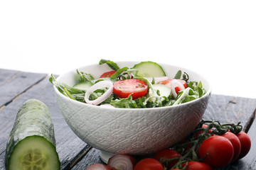 Bowl of salad on wooden table
