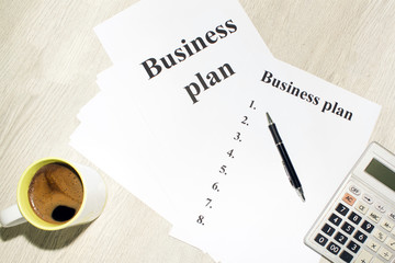 An inscription of the business plan, execution points, there is a notebook and a calculator next to it