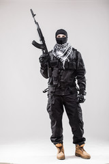 Special forces soldier man hold Machine gun on a grey background
