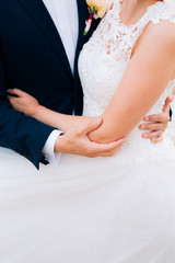 Obraz na płótnie Canvas The groom embraces the bride close-up. Wedding in Montenegro and Croatia.