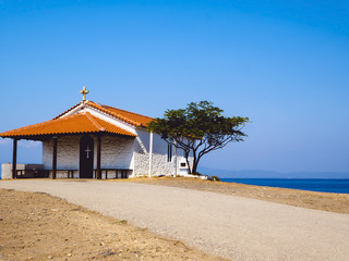 Traditional small white church with sea view in Cassandra peninsula,Greece.
