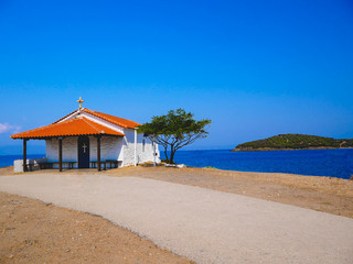 Traditional small white church with sea view in Cassandra peninsula,Greece.