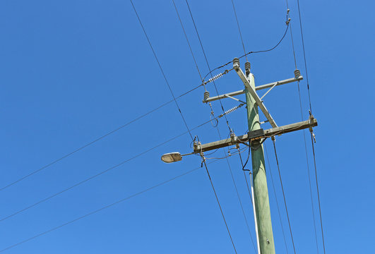 power pole and electricity lines in a blue sky