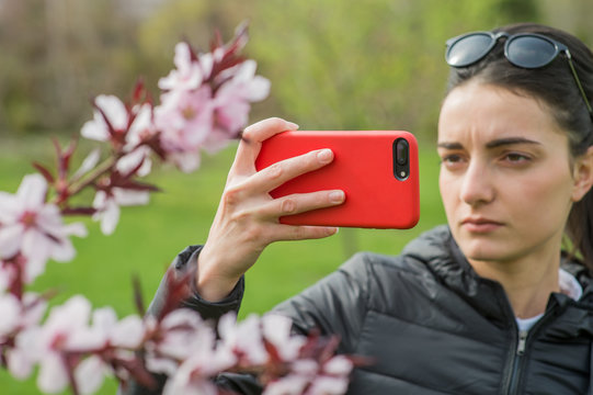 Girl takes pictures of nature and flowers