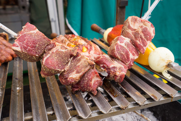 traditional picanha - Brazilian style barbecue. Salted beef on skewers ready to be put onto the grill.

