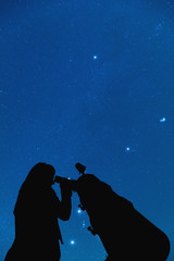 Girl looking at the stars through a telescope. 