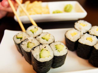 Eating Kappa Maki with Chopsticks.