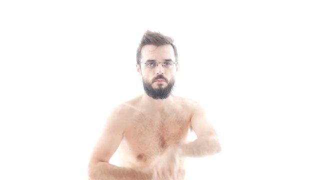 Vigorous self-confident bearded naked man dancing on trap hip-hop music, hi-key studio isolated on white background.