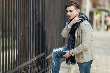 Fototapeta premium Fashionable man standing outdoors with white background