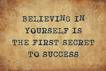 Inspiring motivation quote of believing in yourself is the first secret to success with typewriter text. Distressed Old Paper with Typing image.