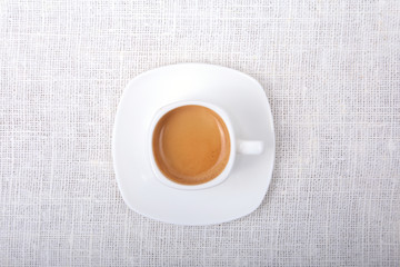 Classic espresso coffee in white cup isolated on white background. Top View.