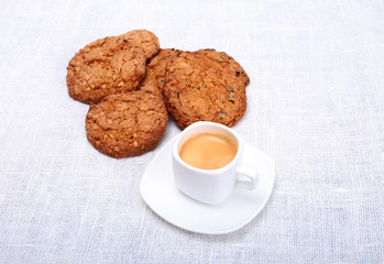 Fresh homemade muffin, cake and white cup of Cappuccino on white background.