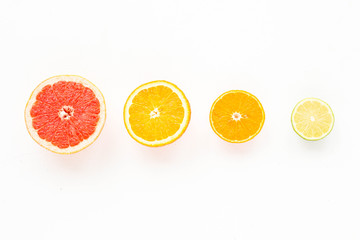 Fruit composition. Fresh colorful citrus fruits on white background. Flat lay, mock up, top view