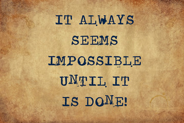 Inspiring motivation quote of it always seems impossible until it is done with typewriter text. Distressed Old Paper with Typing image.