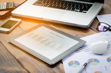 Accessories work laptop on the table, chart, calculator, pen.