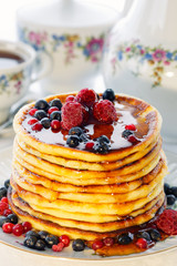 Pancakes with berries and honey, high key