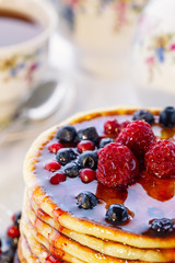 Pancakes with berries and honey, close-up