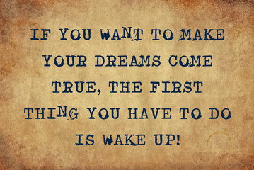 Inspiring motivation quote of if you want to make your dreams come true the first thing you have to do is wake up with typewriter text. Distressed Old Paper with Typing image.