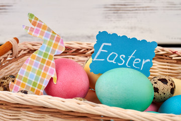 Bright Easter eggs and card. Paper rabbit cutout.