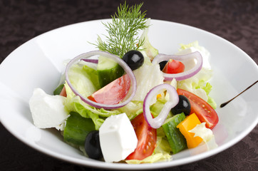 Vegetable salad on a white plate in a restaurant