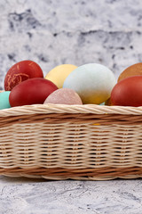 Dyed eggs in a basket. Wicker basket, side view.