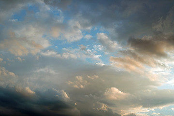 Naklejka na ściany i meble Stormy clouds at sunset