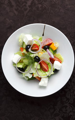Vegetable salad on a white plate in a restaurant