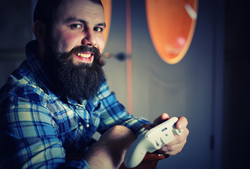 man bearded play joystick