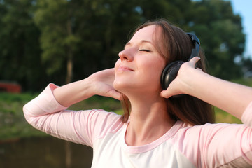girl listen music in headphone outdoor