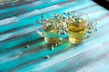 Two transparent glass cups with chamomile tea